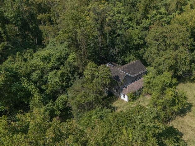 an aerial view of a house with a yard