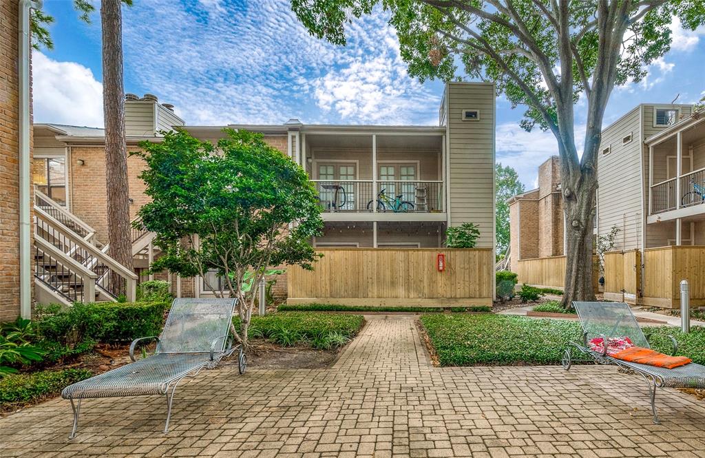 a house that has a tree in front of the house