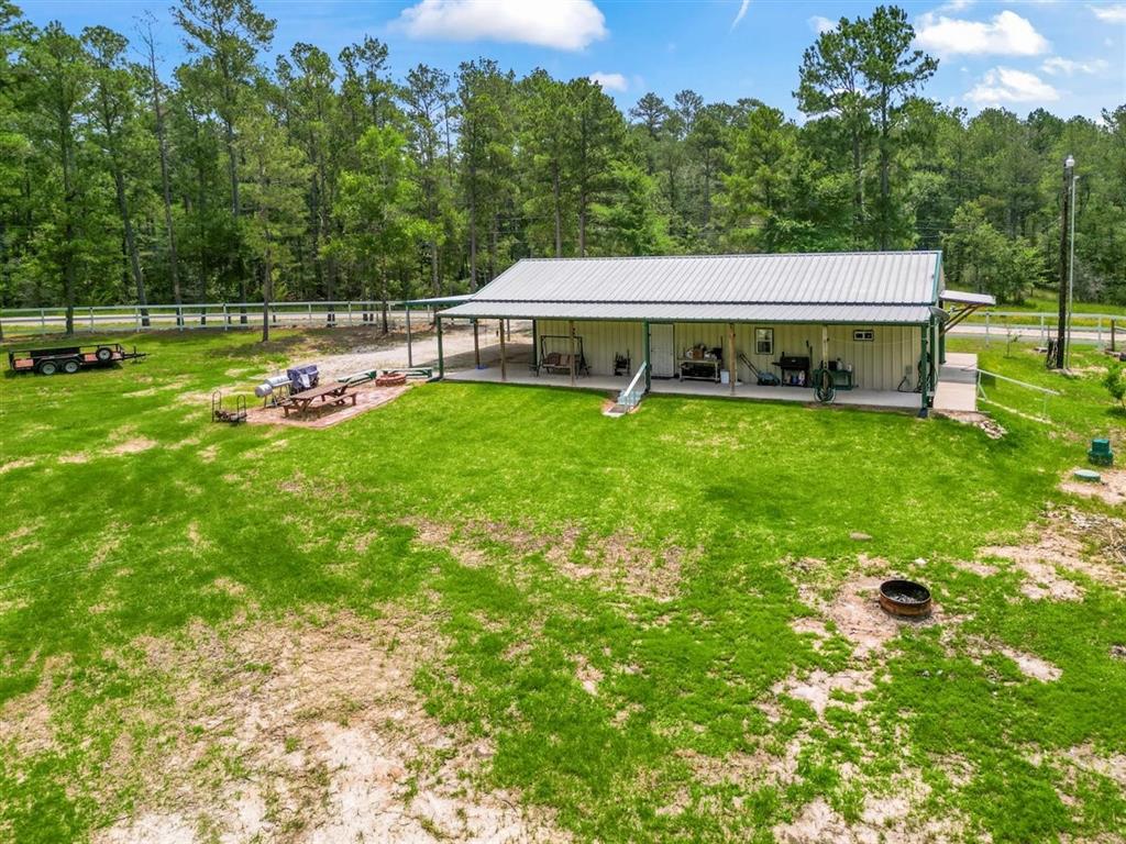 a view of a house with backyard and a sitting area