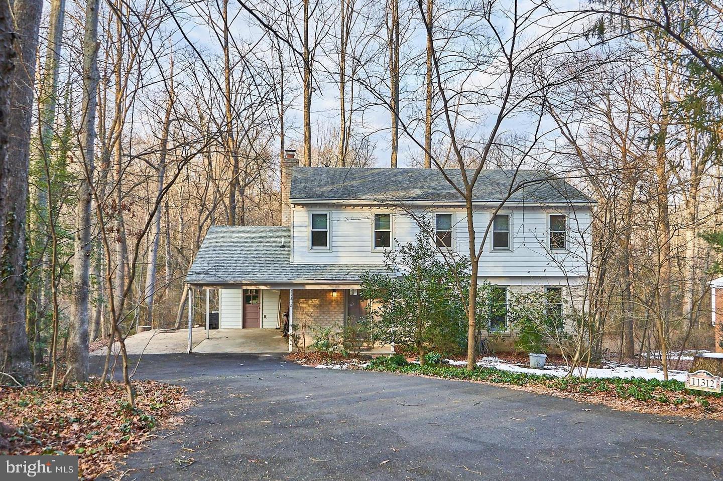 a view of a house with a yard and tree s