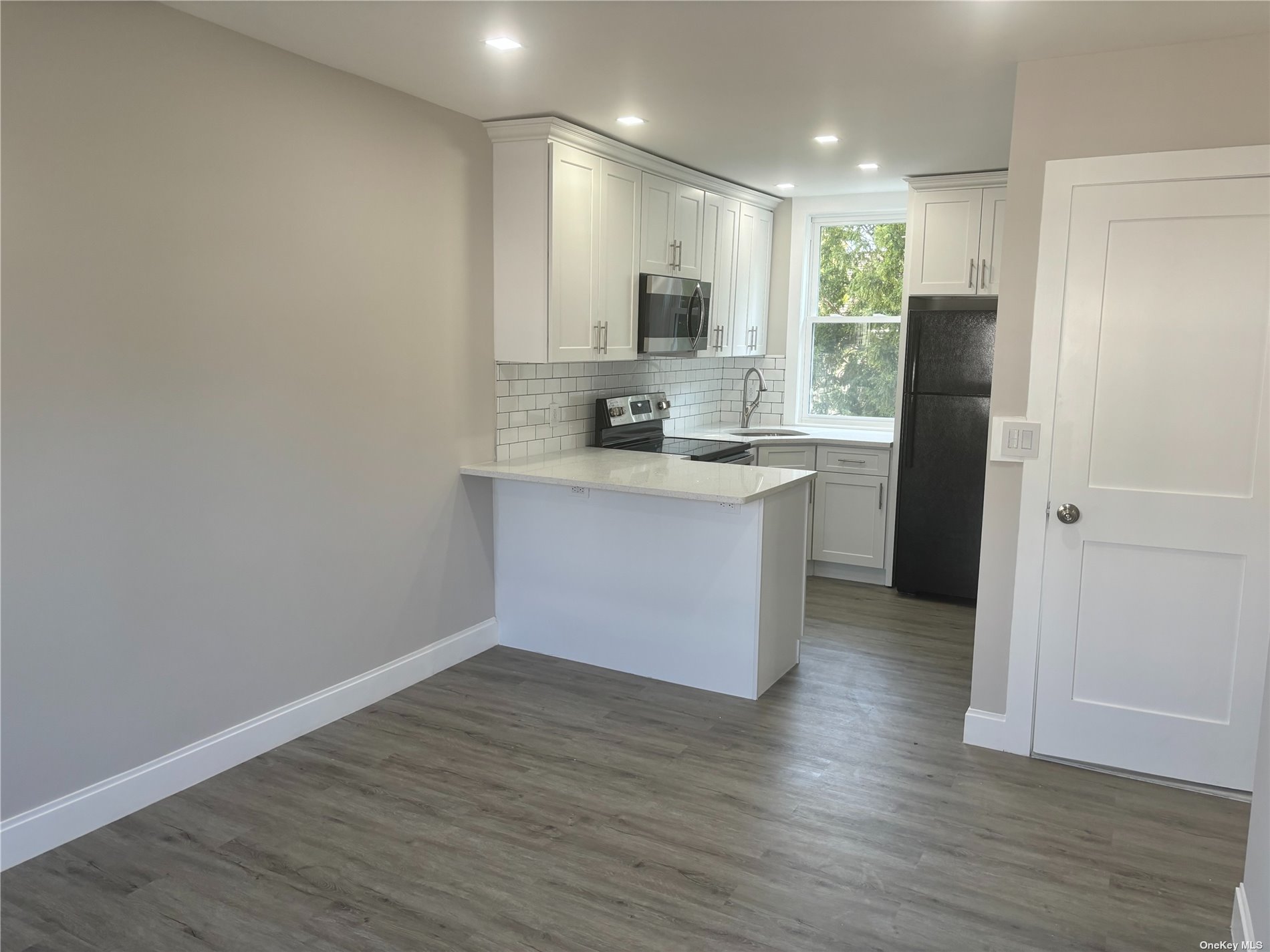 a view of kitchen with wooden floor