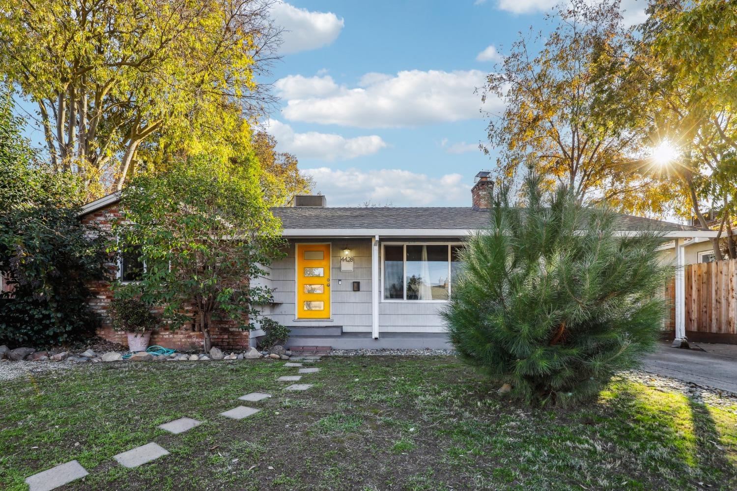 a front view of a house with a garden