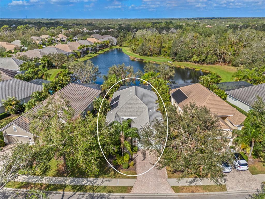 an aerial view of a house with a lake view