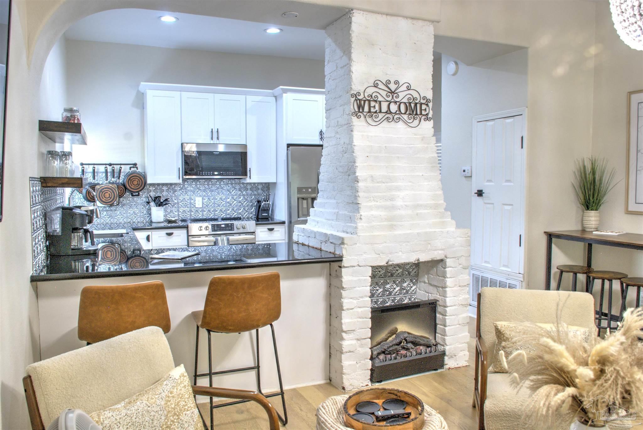 a kitchen with granite countertop counter top space a sink stainless steel appliances and cabinets