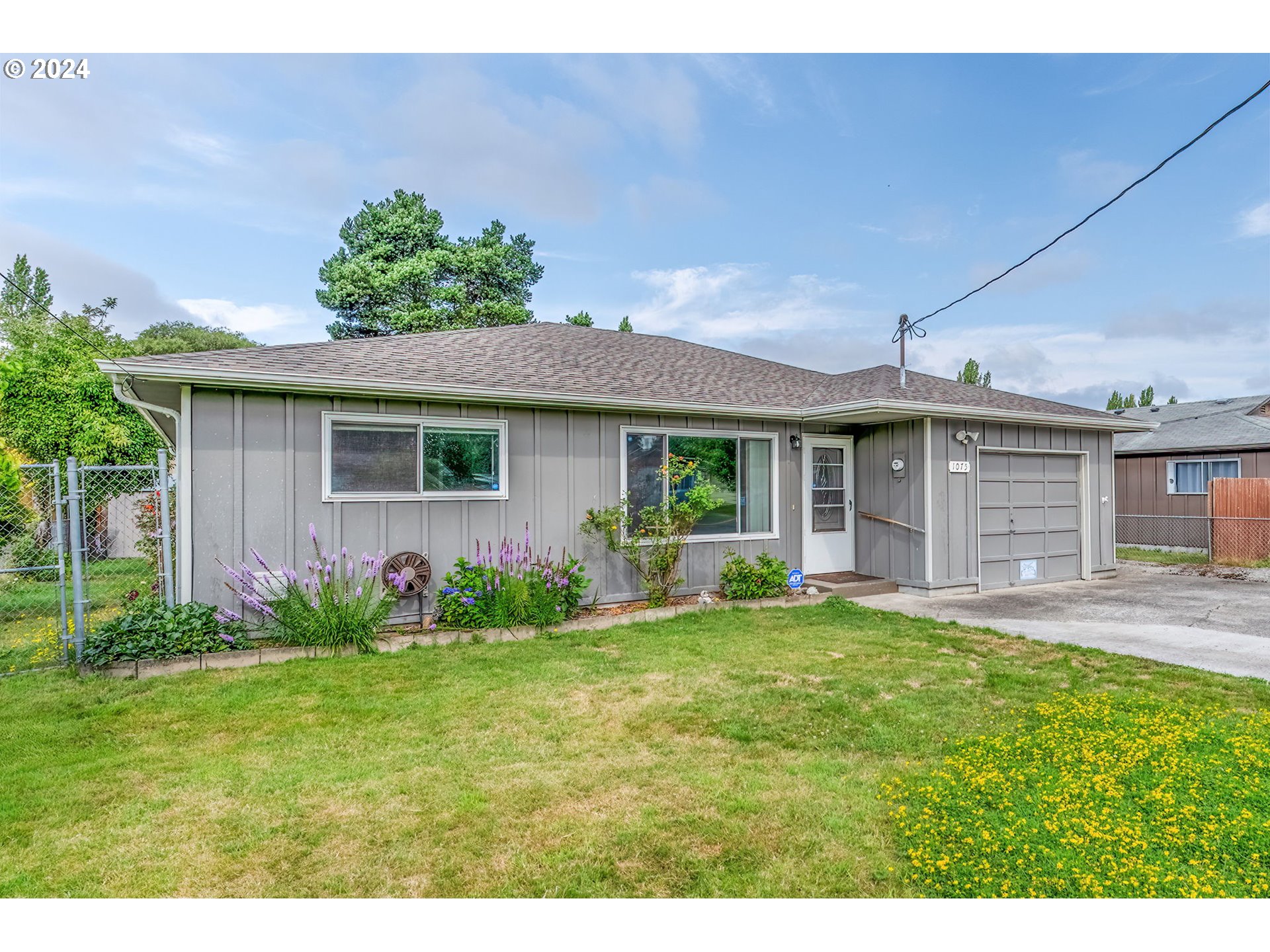 a front view of house with yard and outdoor seating