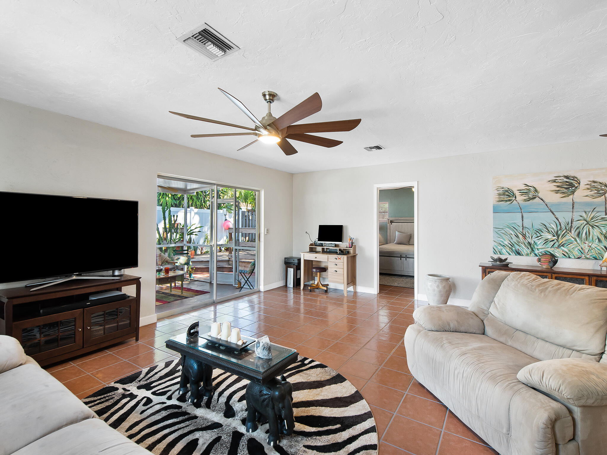 a living room with furniture and a flat screen tv