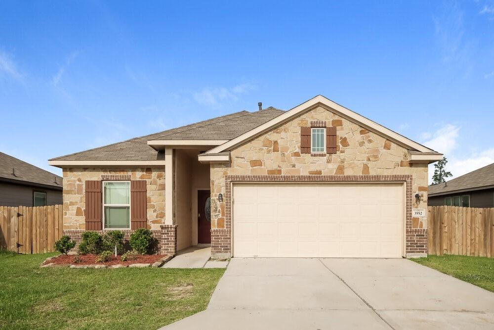 a front view of a house with a yard and garage