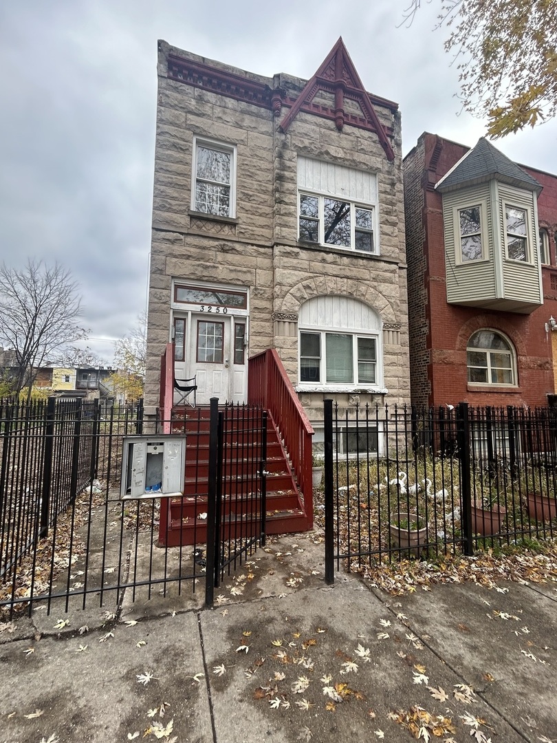 a view of a house with iron fence