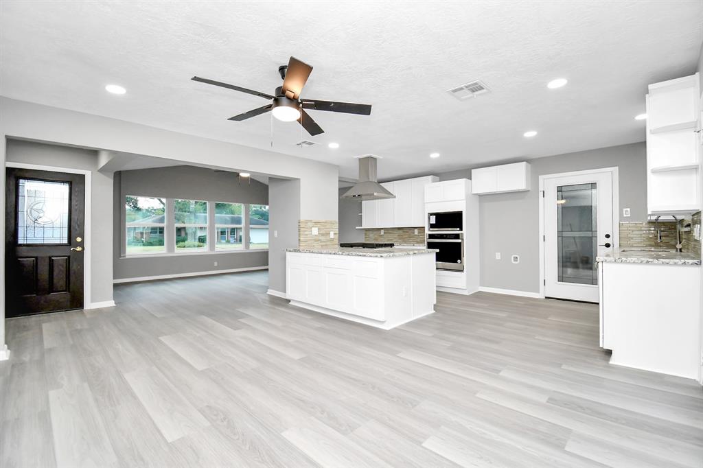 a view of kitchen with cabinets and wooden floor