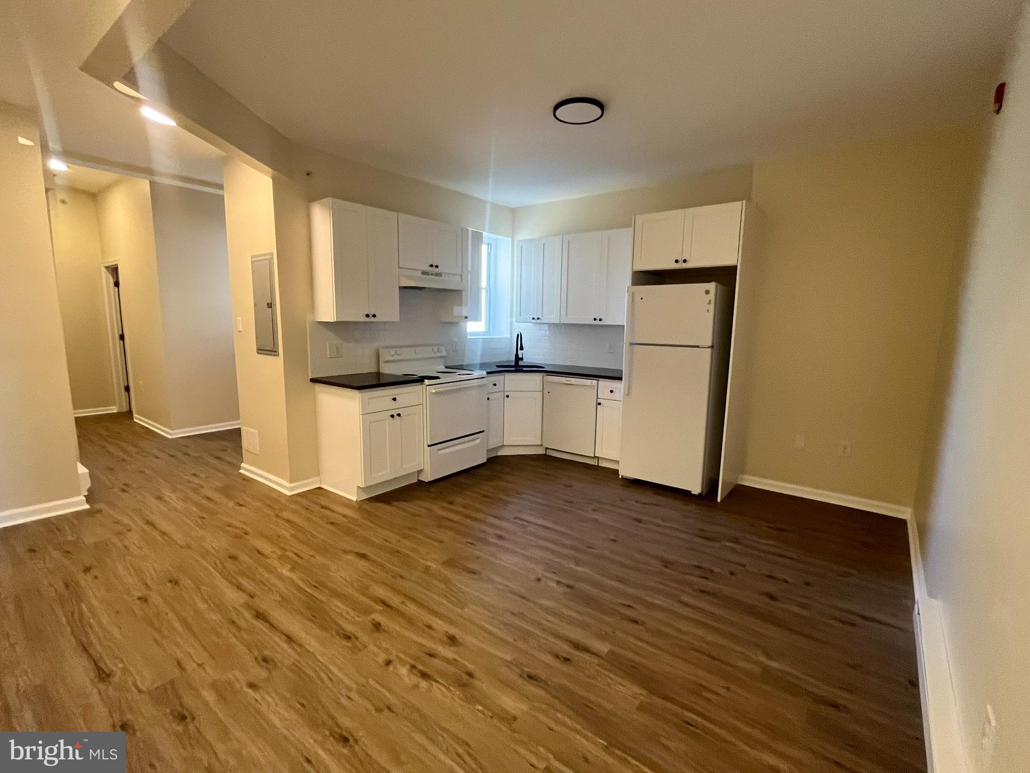 a kitchen with a sink and a refrigerator