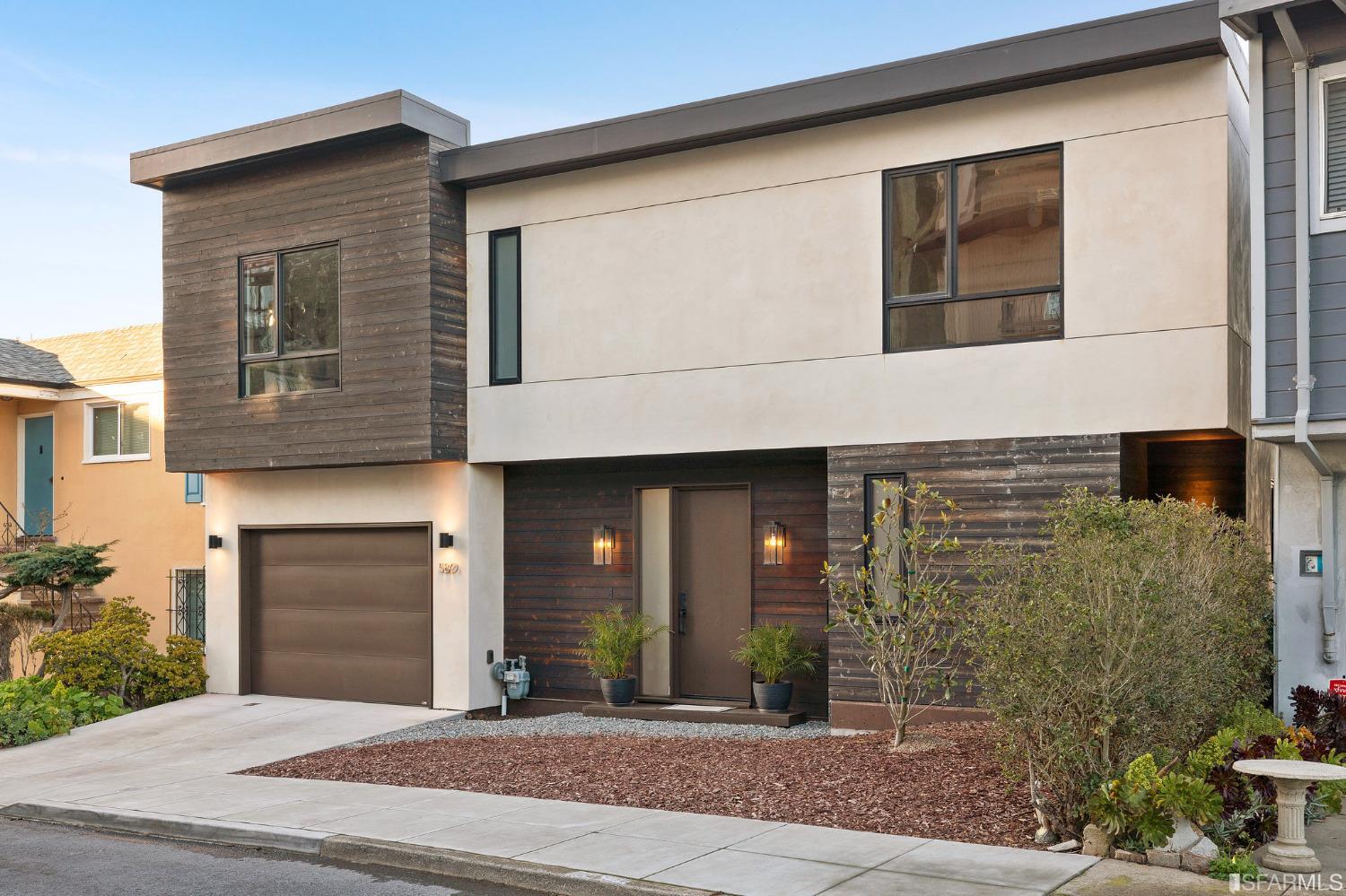 a front view of a house with garage