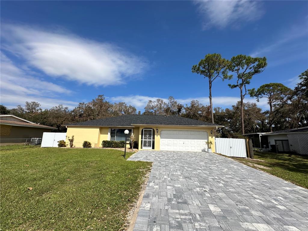 a view of a house with a yard