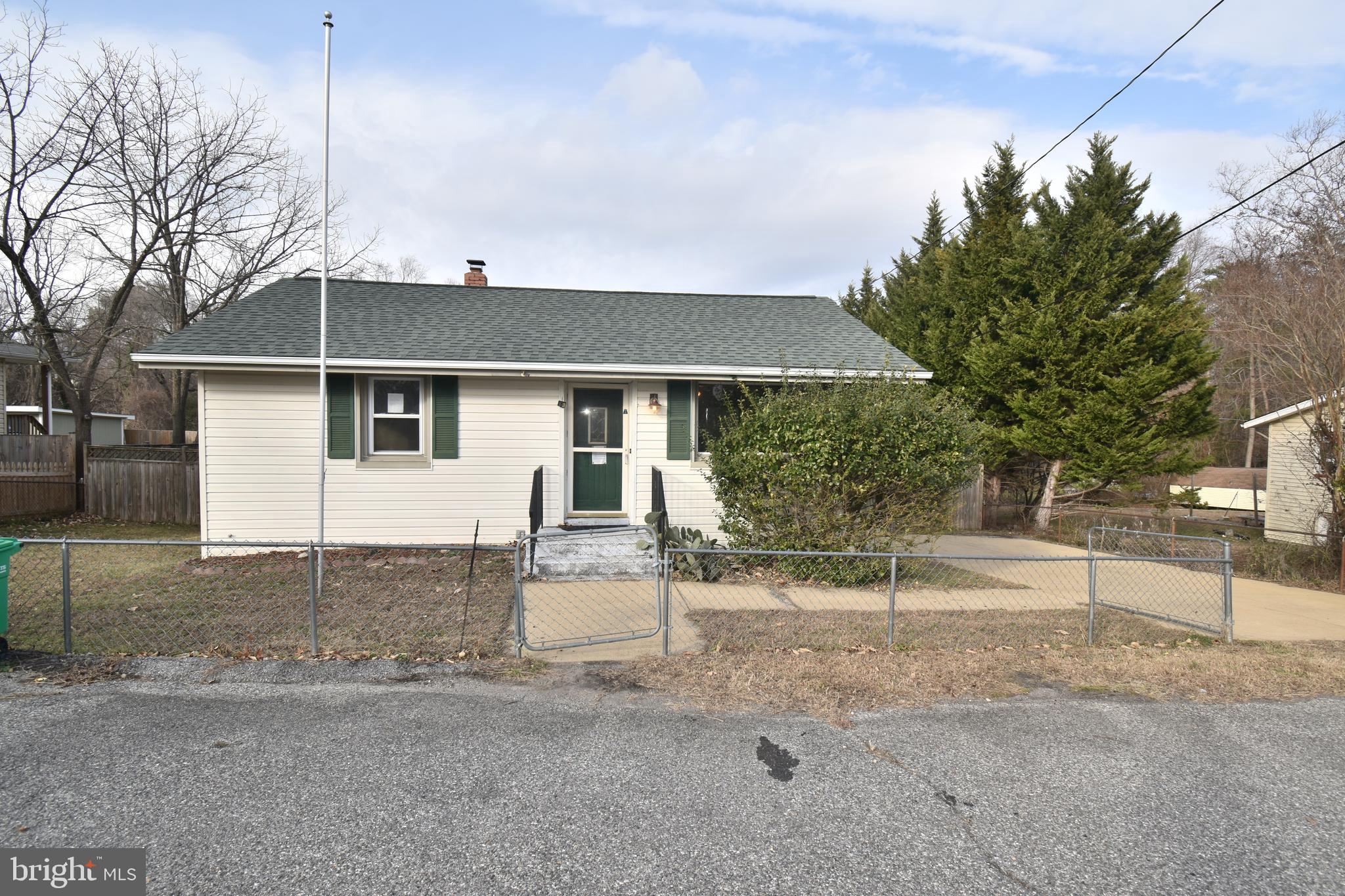 a view of a white house with a yard and garage