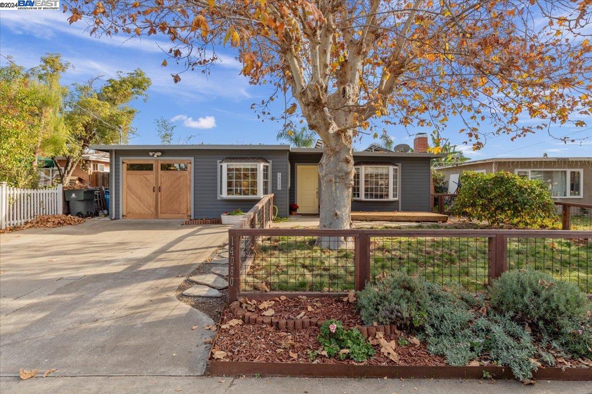 front view of a house with a tree