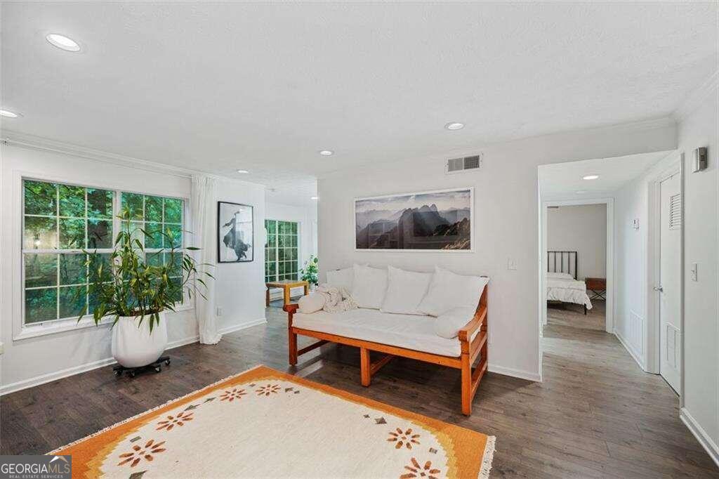 a living room with furniture and a wooden floor