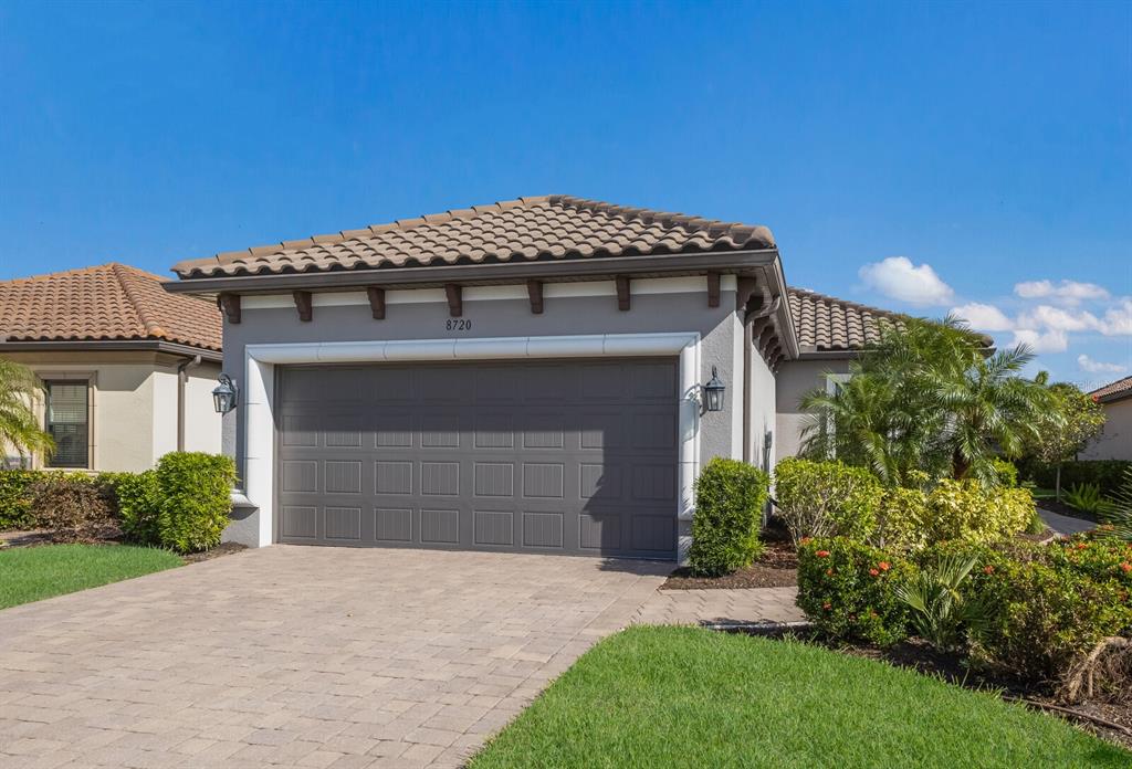 a front view of a house with a yard and garage