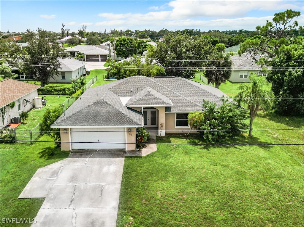 an aerial view of a house with swimming pool garden and patio