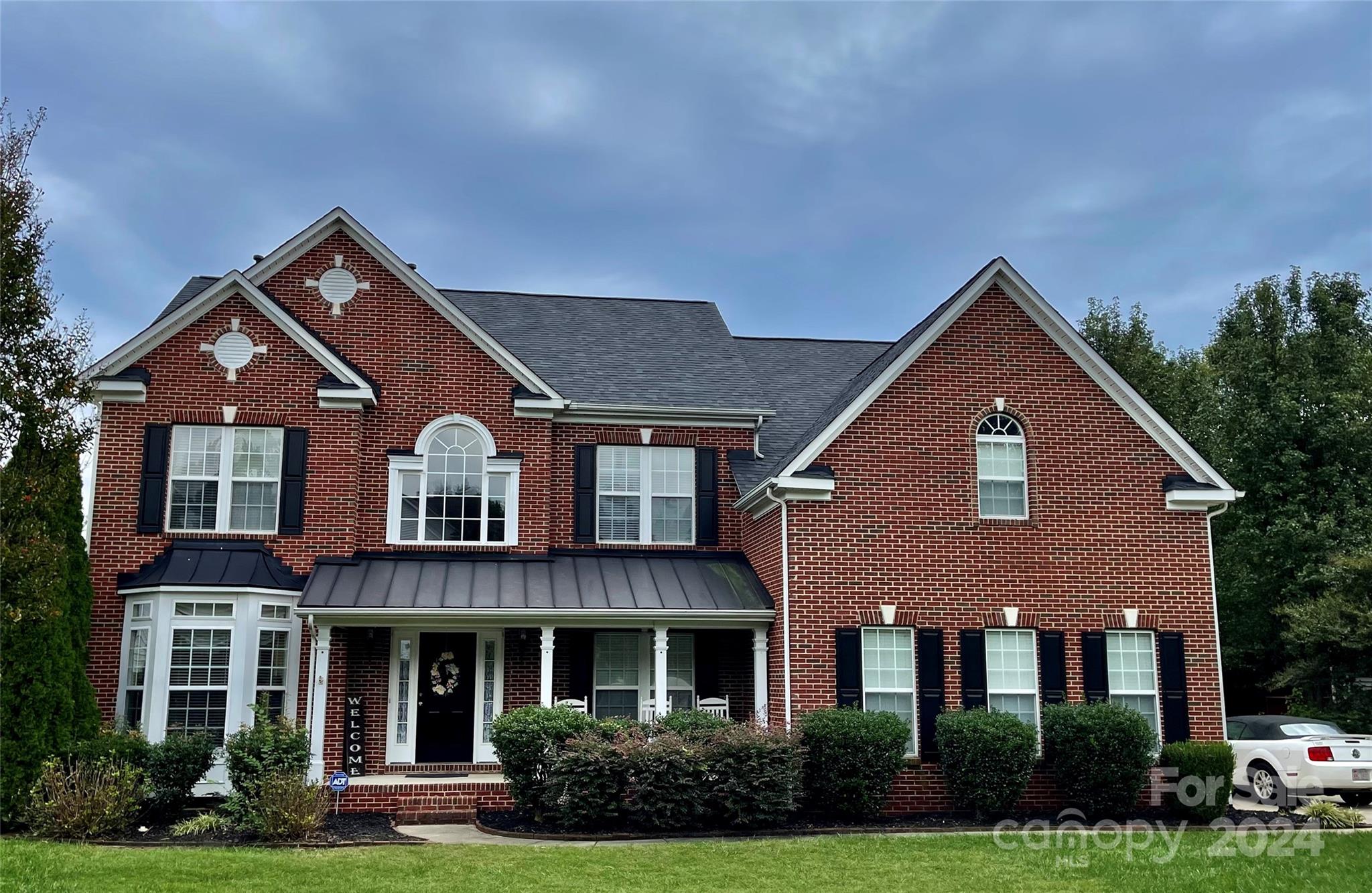 front view of brick house with a yard