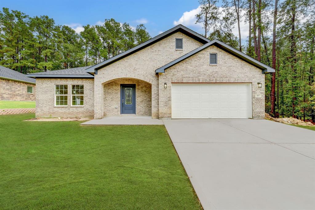 a view of backyard of house with green space