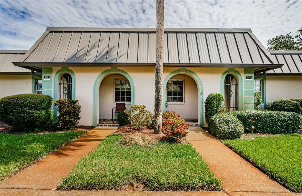 a front view of house with yard and outdoor seating