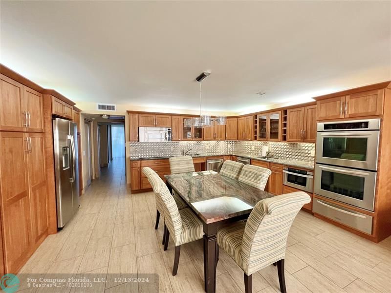 a dining room with furniture and a kitchen view