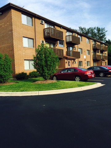 a front view of a house with a garden and yard