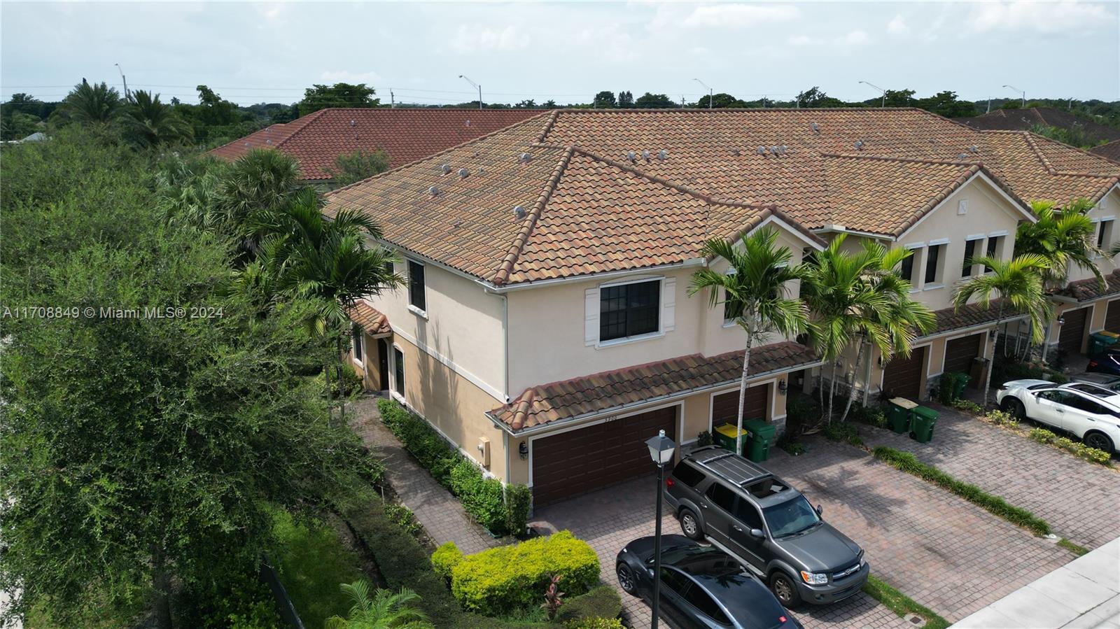 an aerial view of house with backyard space and balcony