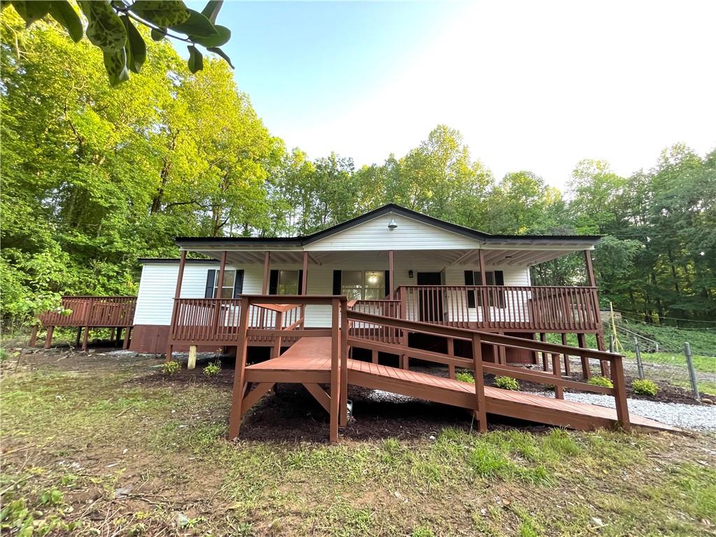 a front view of a house with a yard and deck