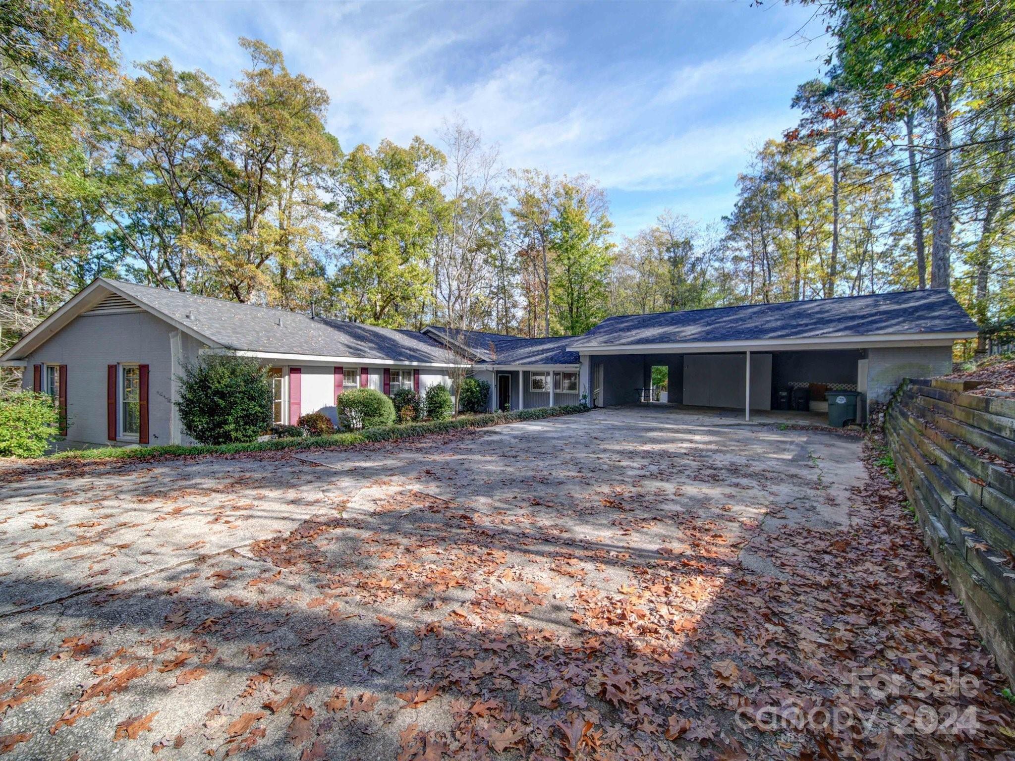 a view of a house with a yard and a tree