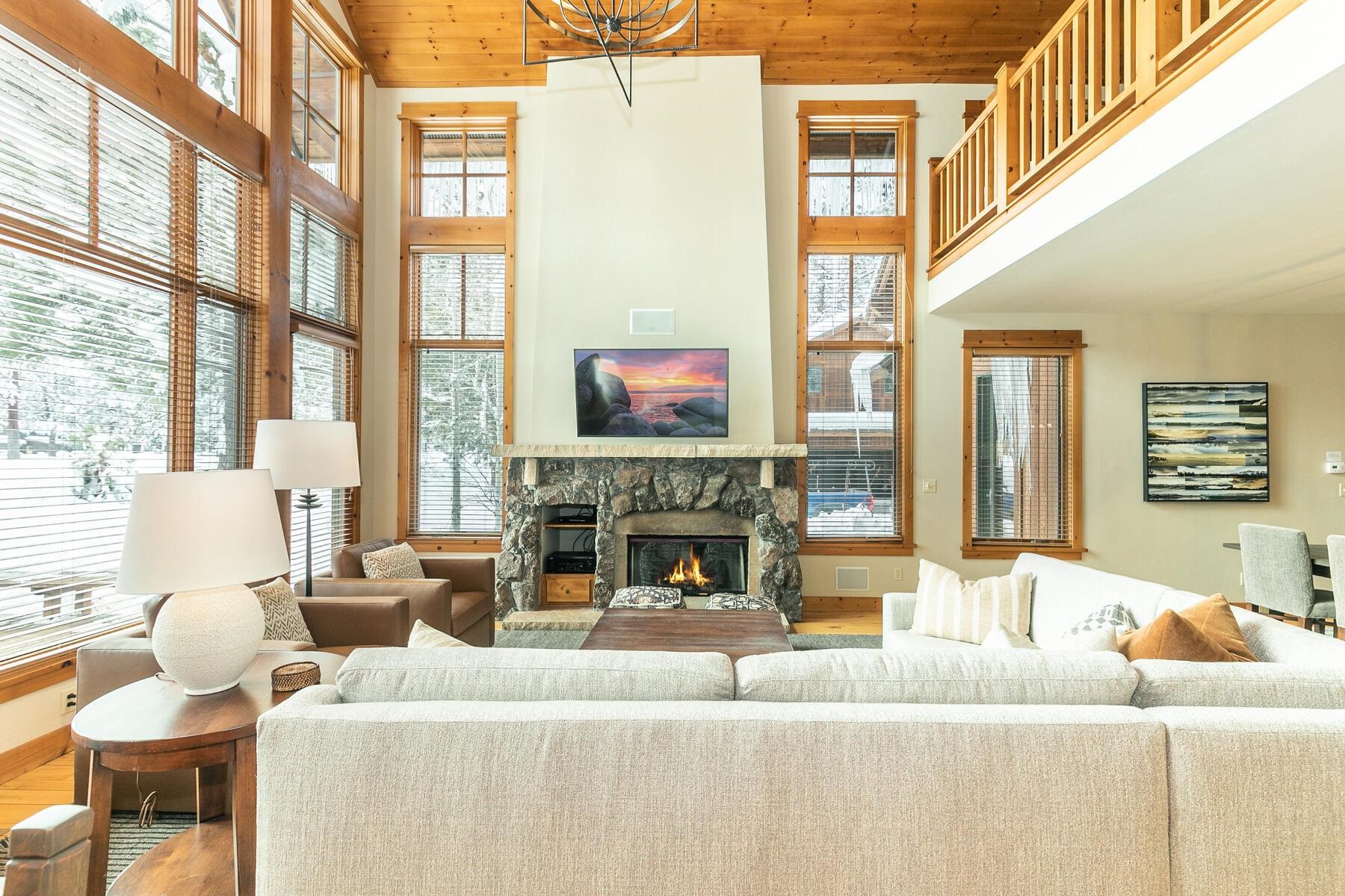 a living room with fireplace furniture and a large window