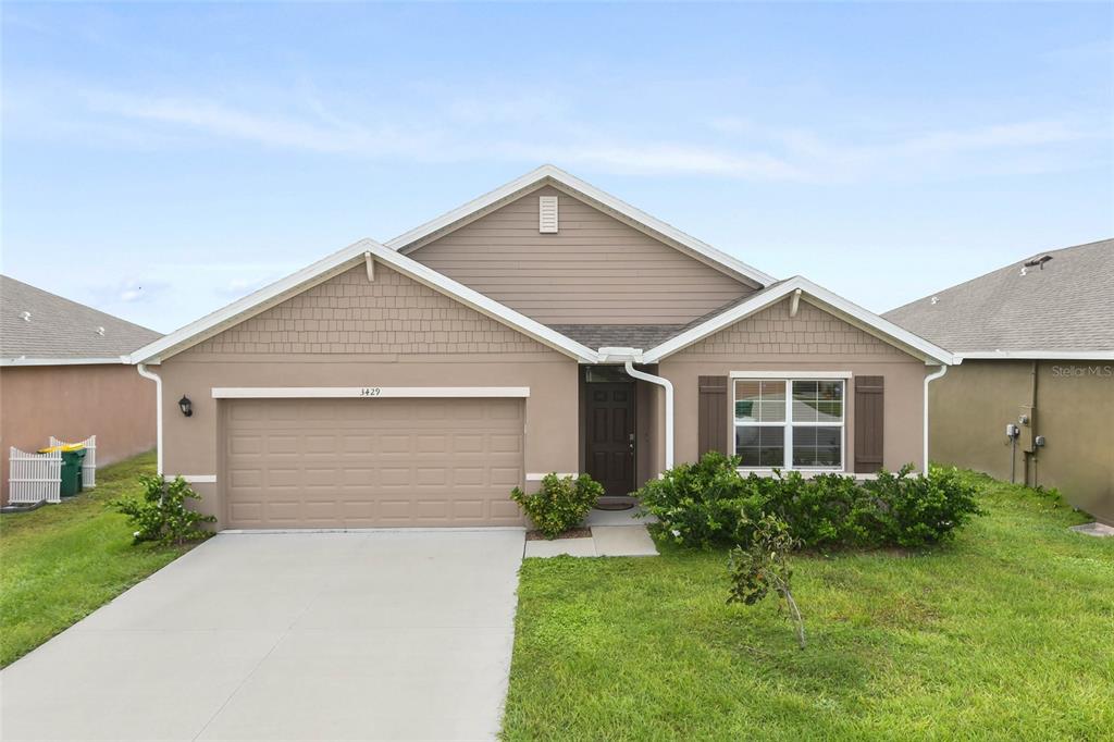 a view of a house with a yard and garage