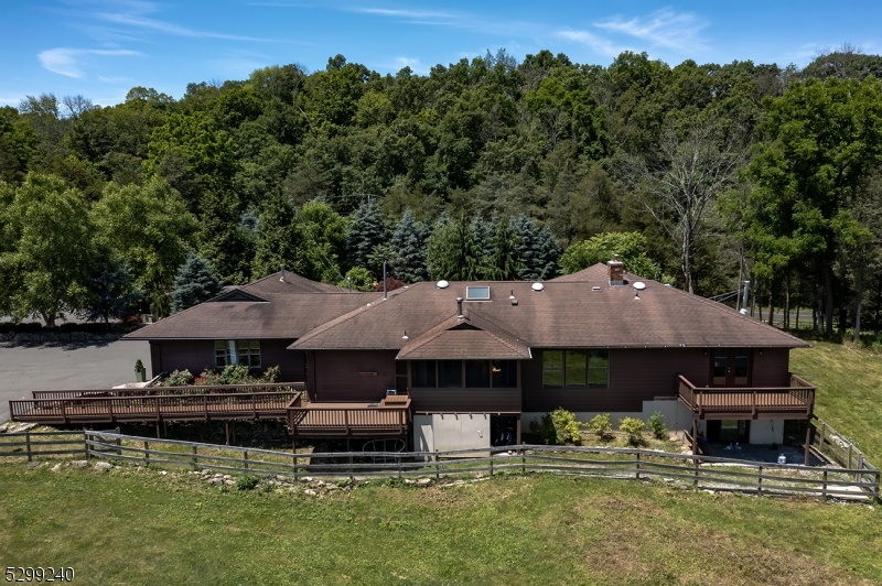 a aerial view of a house with swimming pool and a yard