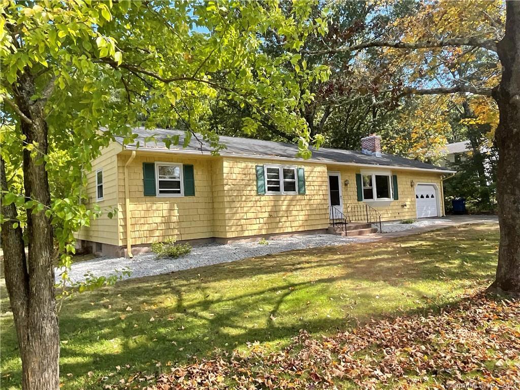 a view of a house with a backyard