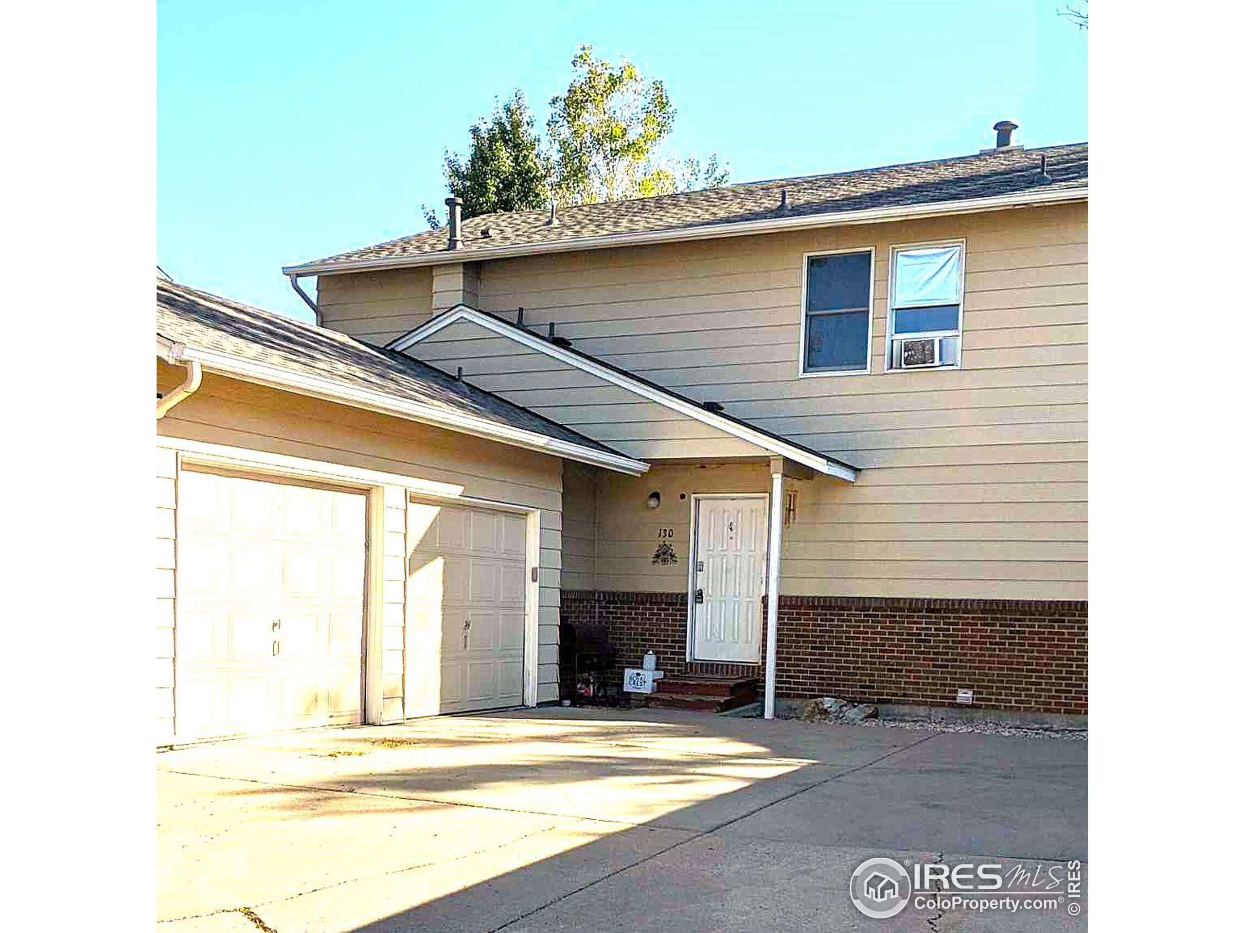 a view of a house with a patio and a yard