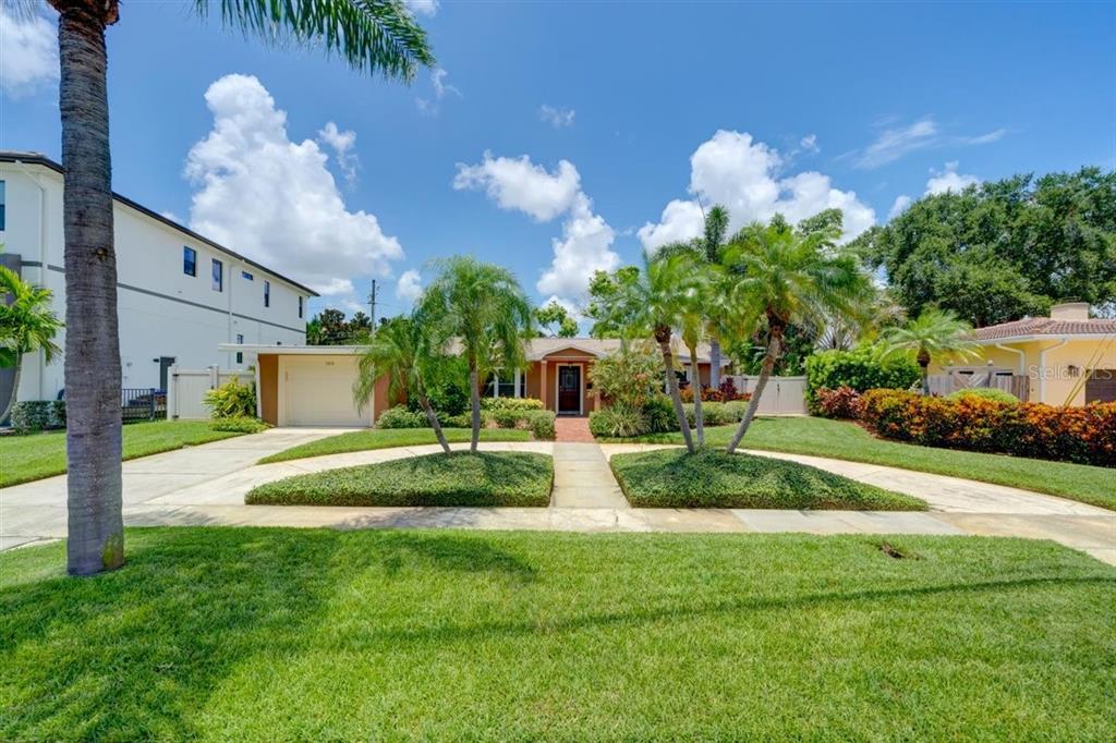 a view of a house with a yard and a garden