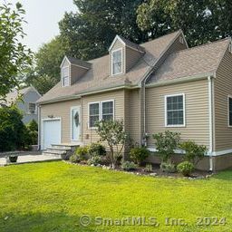 a front view of house with yard and outdoor seating