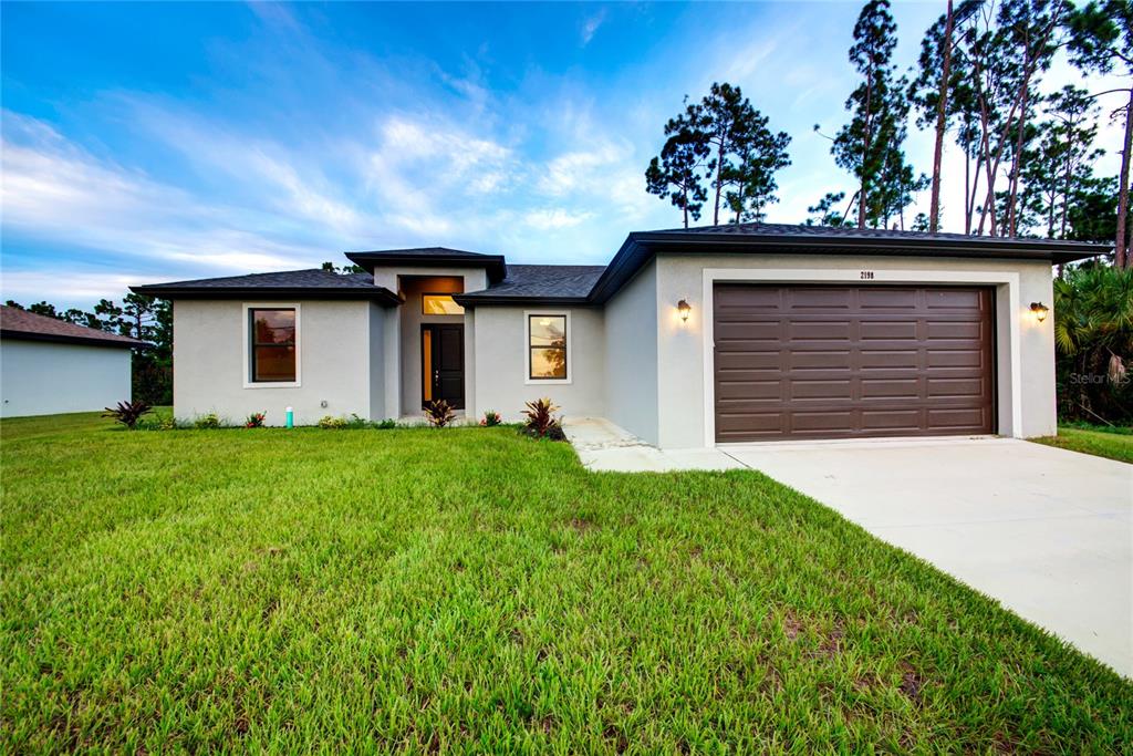 a view of a house with a yard