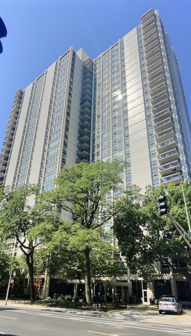 a view of a tall building next to a road