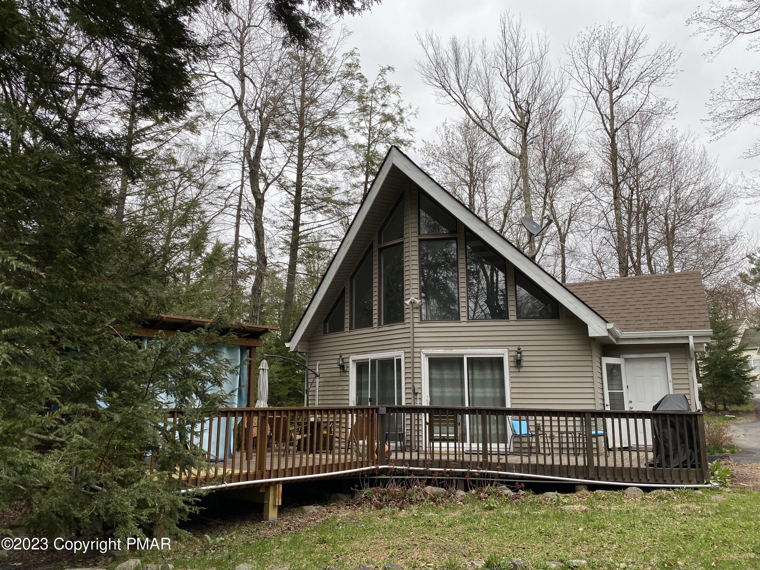 a view of a house with a yard window and deck