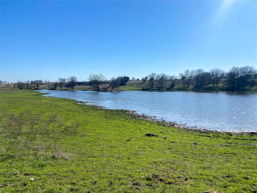 a view of a lake with houses in the back