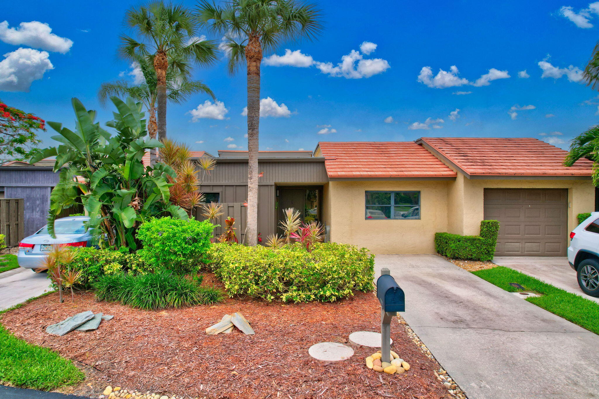 a front view of a house with a yard and outdoor seating