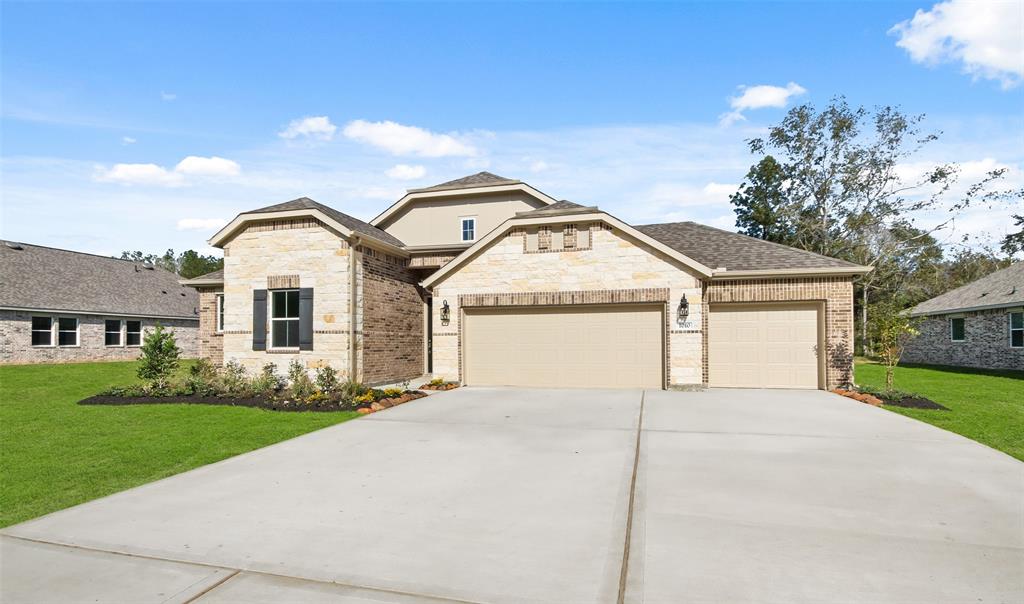 a view of a house with a yard and garage