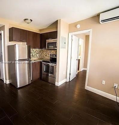 a kitchen with stainless steel appliances a refrigerator and a stove top oven