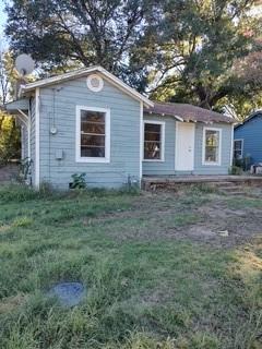 a front view of house with yard and trees