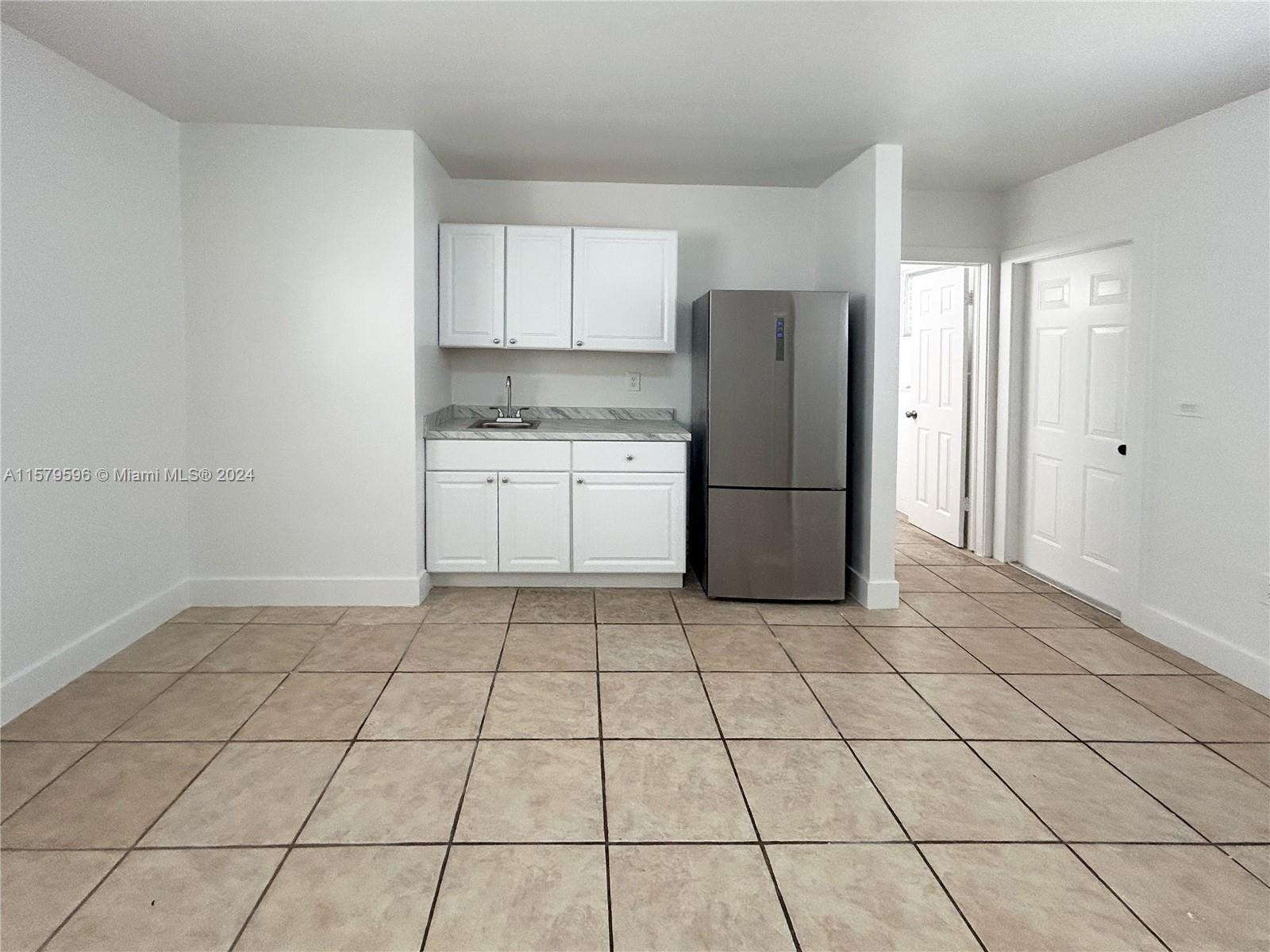 a kitchen with a stove a refrigerator and cabinets