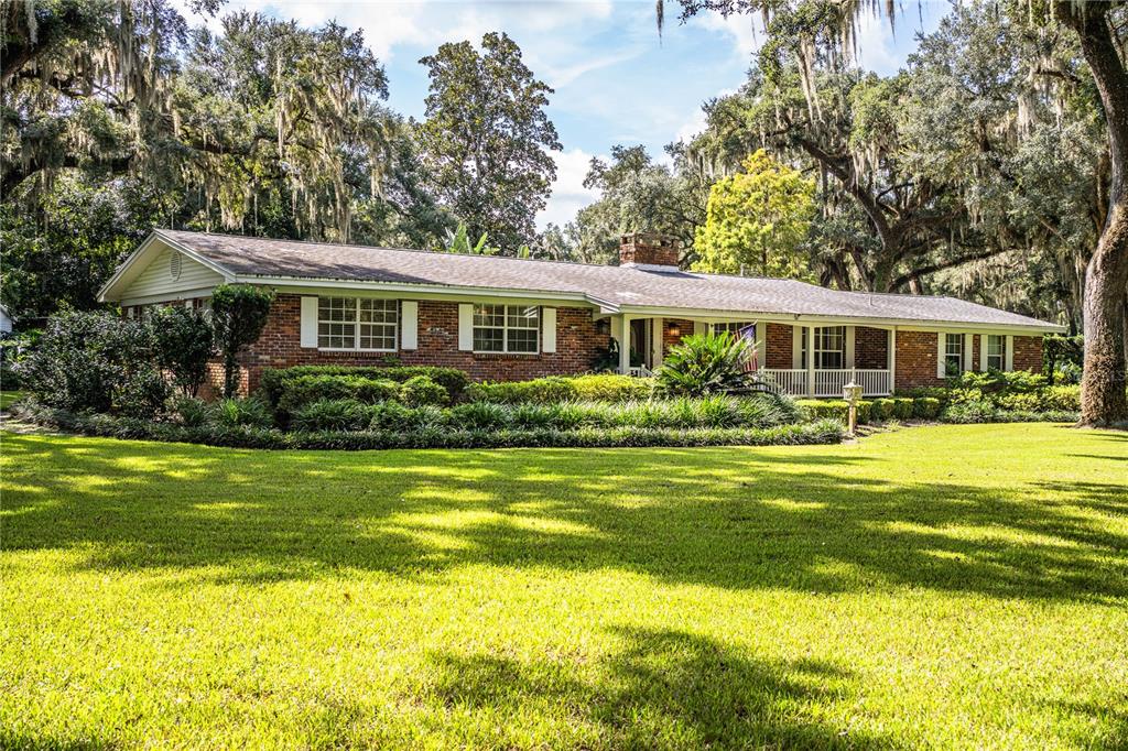 a front view of a house with swimming pool and porch