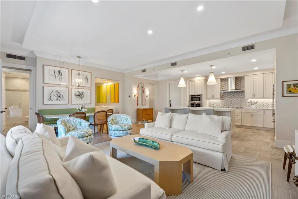 a living room with furniture and kitchen view