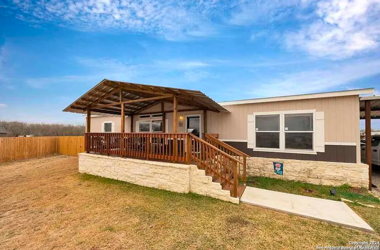 a view of a house with wooden fence