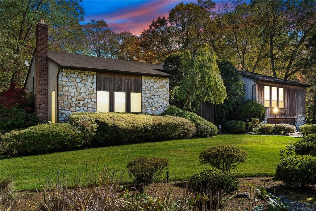 Property exterior at dusk featuring a yard