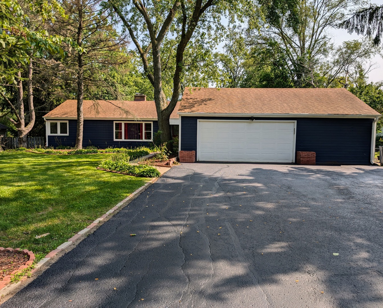 a front view of house with yard and trees